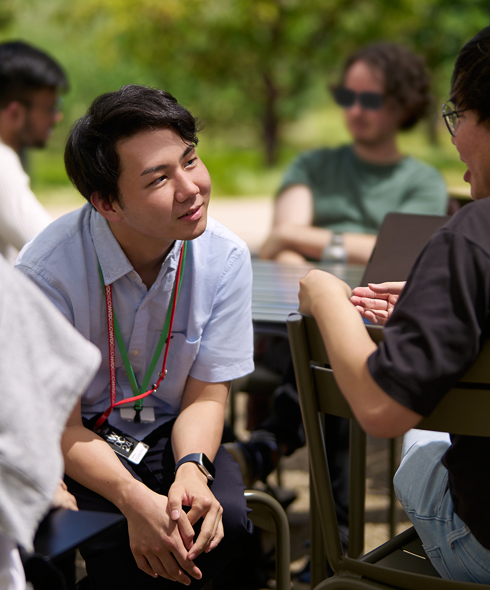 Distinguished Winner Keitaro Kawahara from Japan engaging in conversation with fellow attendees outdoors at WWDC, creator of PuzzlePix